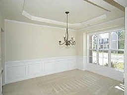 Separate formal dining room with trey ceiling and custom trim work.