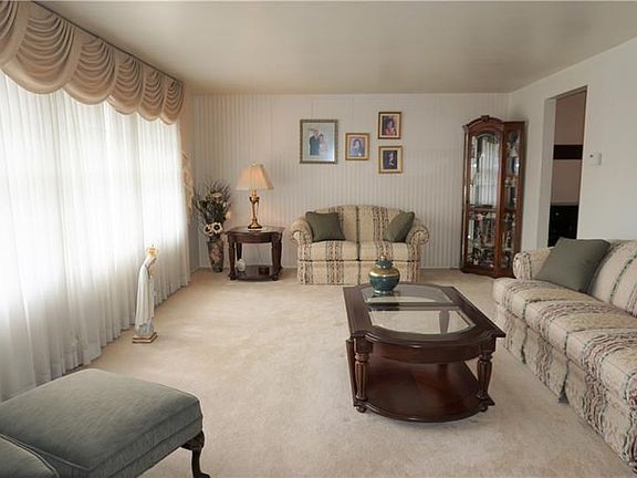 Large Living Room with Large Picture Window which allows natural light to come shining thru