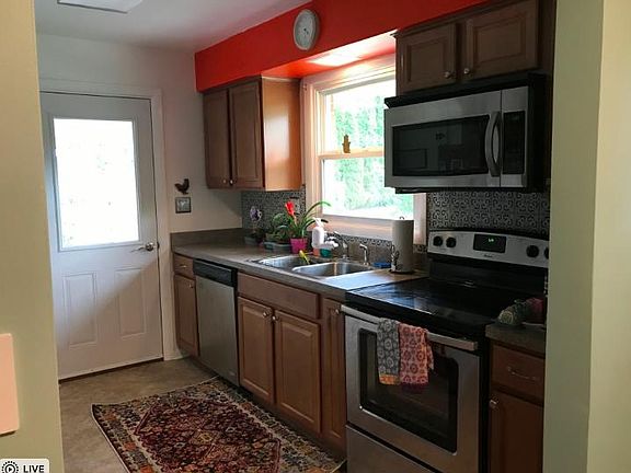Remodeled kitchen with Spanish tile backsplash and stainless