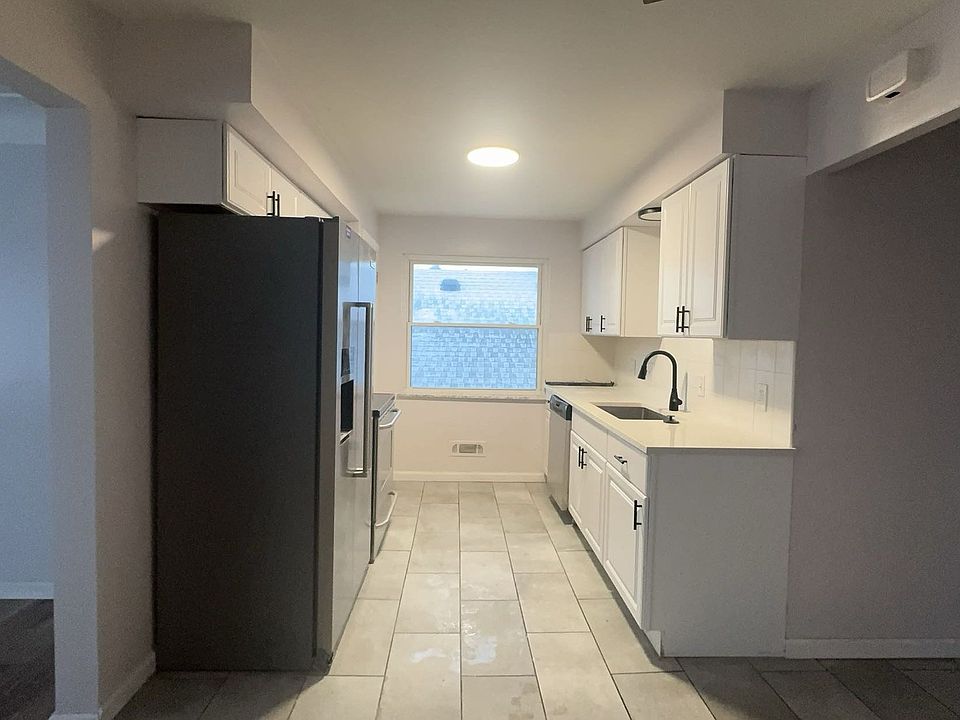 Open concept kitchen with modern quartz countertop and modern farmhouse feel and styling. Stainless Steel Fridge, Stove, Microwave & Dishwasher