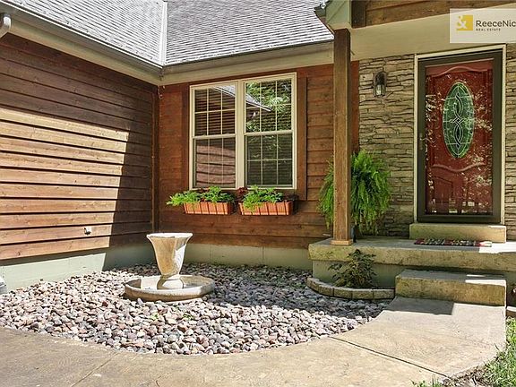 Freshly landscaped, flower boxes, fountain stays. First impression to what lies behind this door!