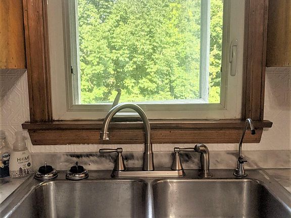 Kitchen sink overlooks back yard.