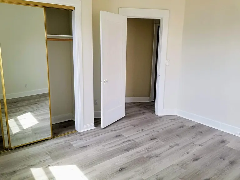 Bedroom with new floors, new window, new closet and paint