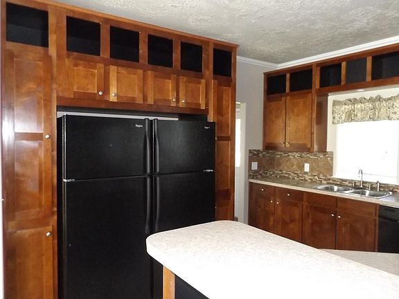 Matching dual refrigerator and island in kitchen.