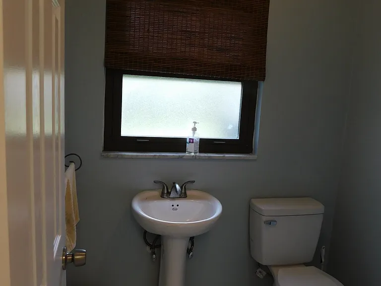 The half bath is at the end of the hallway. We are facing north.