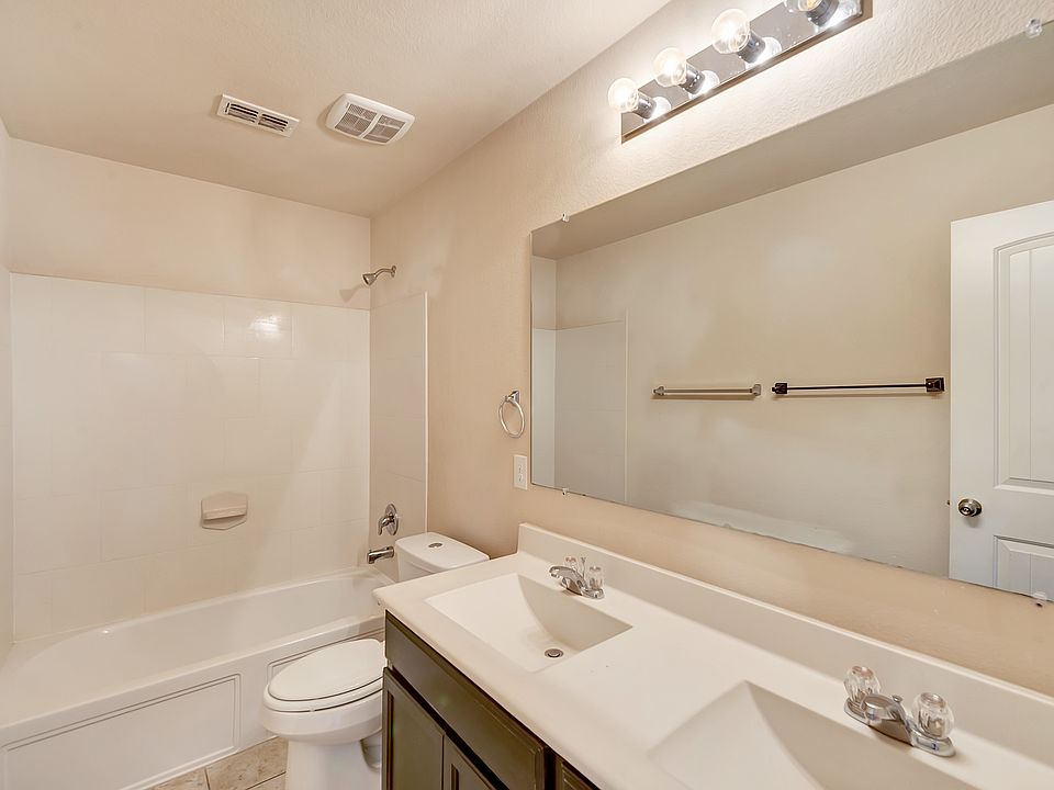 Full bathroom 2 with double vanity and full-sized mirror, and shower-bathtub combination
