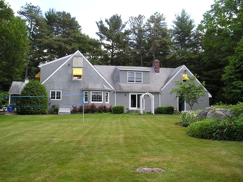 Back of house faces huge landscaped backyard and pond