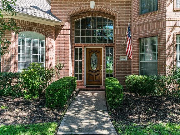 Inviting front entry with leaded glass front door.