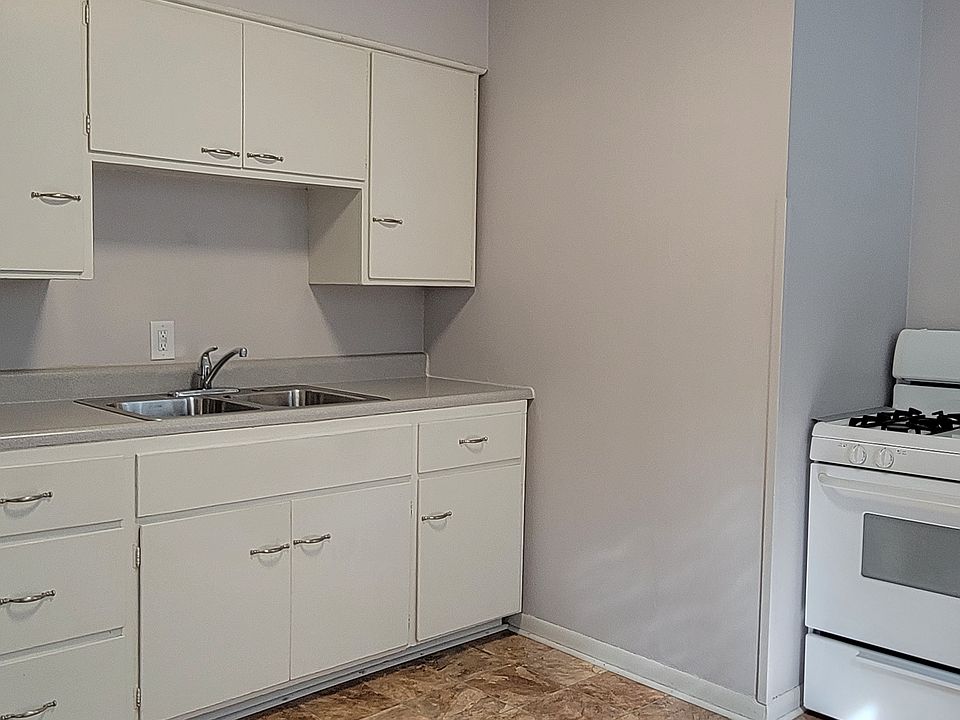 Kitchen cabinets, stove, and fridge
