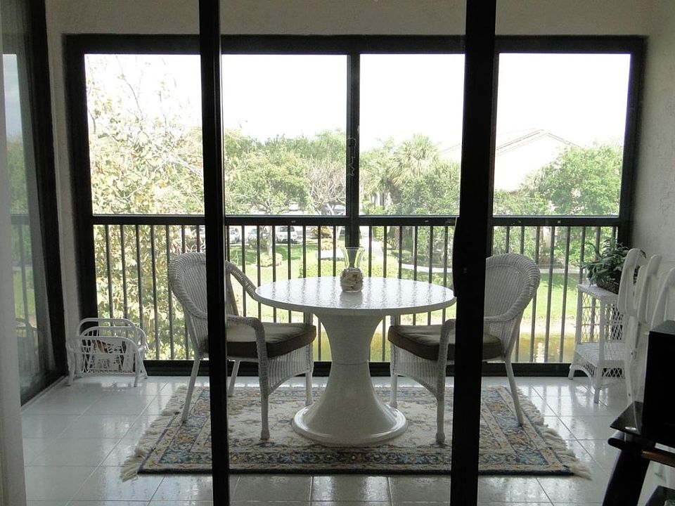 Glass enclosed balcony overlooking pond