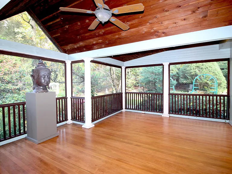 Screen Porch features wood floor and a view of the rear Garden