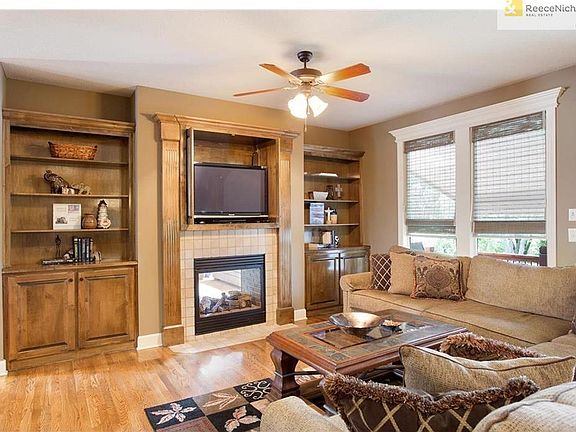 Family room provides a gas see through fireplace with beautiful built in cabinets.
