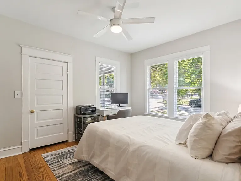 Second bedroom from bedroom doorway. Door opens into walk-in closet. Window behind the desk opens onto the front porch.