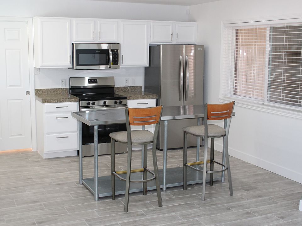 Kitchen has pocket door that leads to laundry room