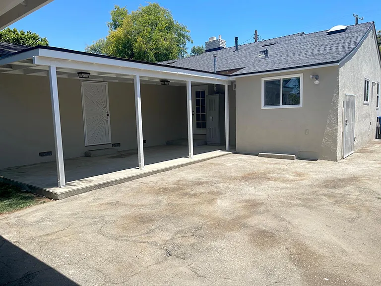 Covered patio great for entertaining with access from both main bedroom and den.