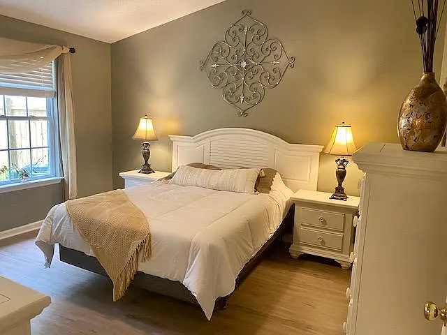 Hygge-inspired Large Master Bedroom with brand new queen-size mattress and new flooring with view of enclosed patio