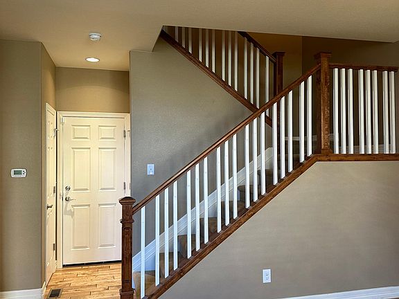 From Entryway showing garage door and stairs to second floor