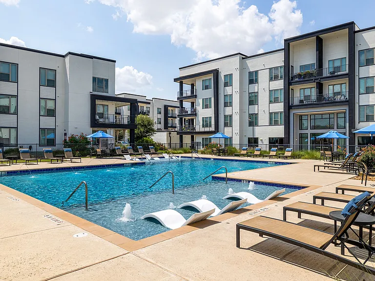Rhythm Resort-Style Pool with Chaise Lounge Seating and Sundeck