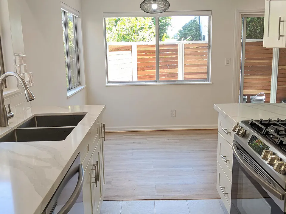 Kitchen with stainless steel appliances and adjacent dining room
