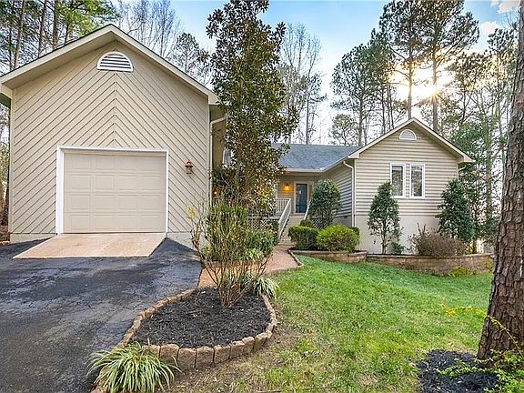Beautifully landscaped! Paved driveway and attached 1 car garage!