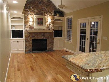 SPACIOUS FAMILY ROOM WITH FLOOR TO CEILING STONE GAS FIREPLACE