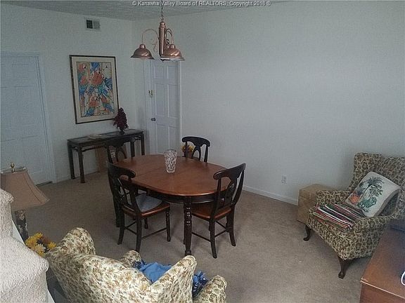 Dining room with door that enters onto enclosed porch area.