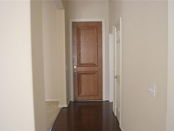 Foyer featuring a tall solid wood door.
