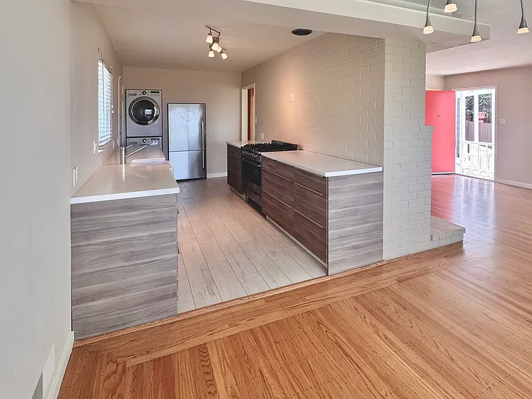 The bright, airy kitchen features Italian ceramic flooring, high end appliances and ample storage space.