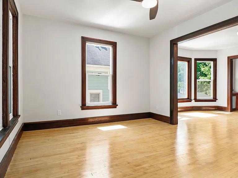 Cute living area, gleamng hardwoods and lots of light. Shot empty so you can imagine your own design!