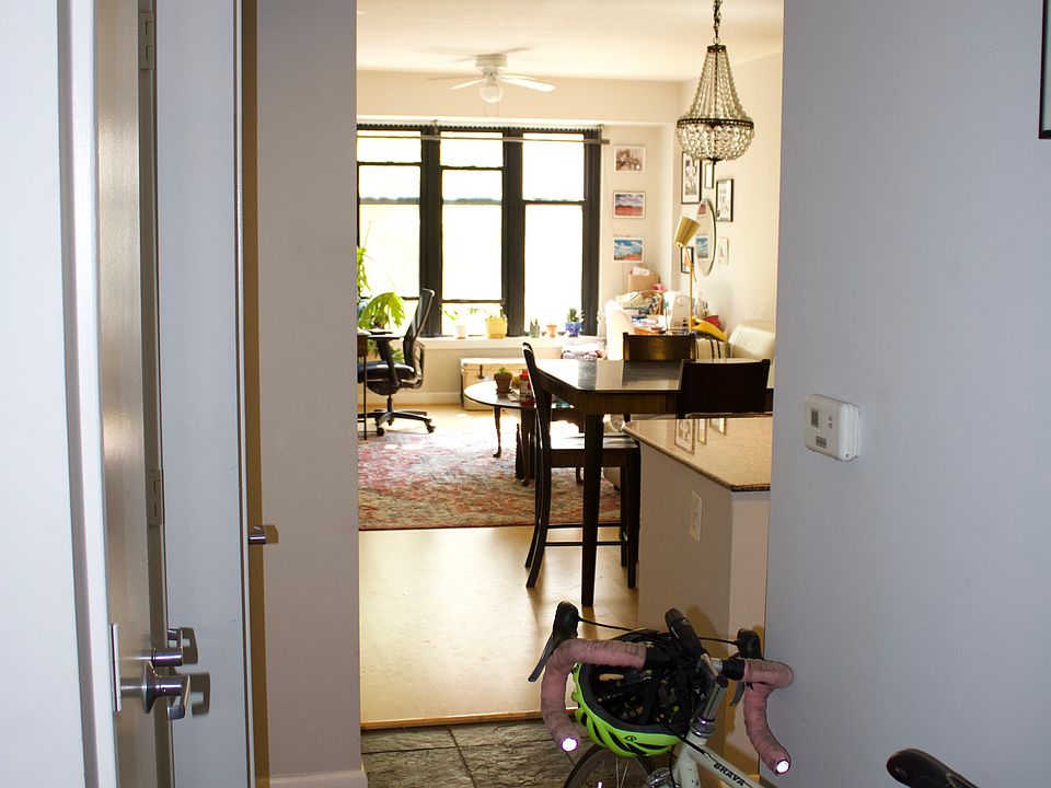 Entrance from hallway looking into living area with kitchen to right