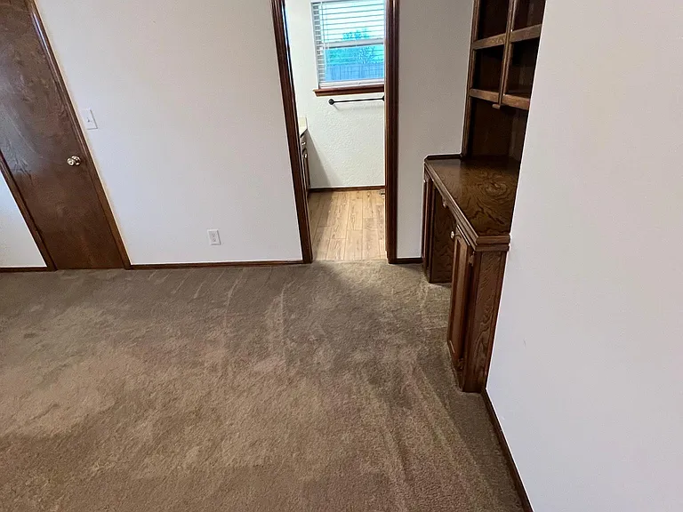 Entry into master bathroom. Has a desk and shelves above