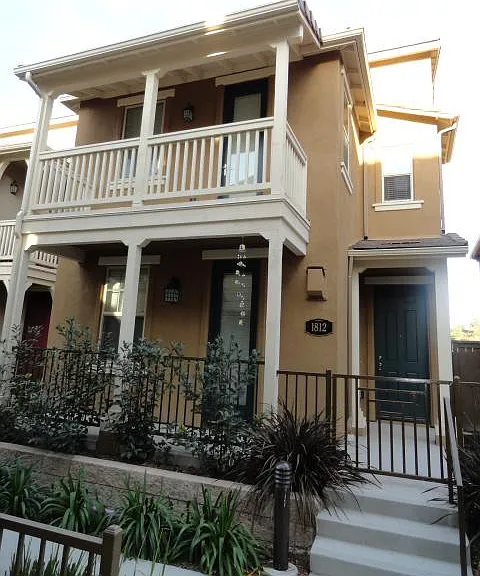 Front sidewalk entry to the home, with a two-car garage accessed in the rear via the street.