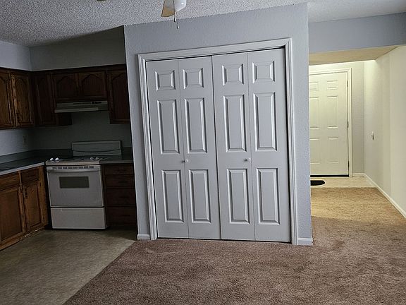 Dining room showing laundry hookups in bifolding & showing entry door.