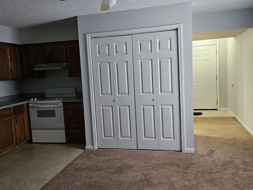 Dining room showing laundry hookups in bifolding & showing entry door.