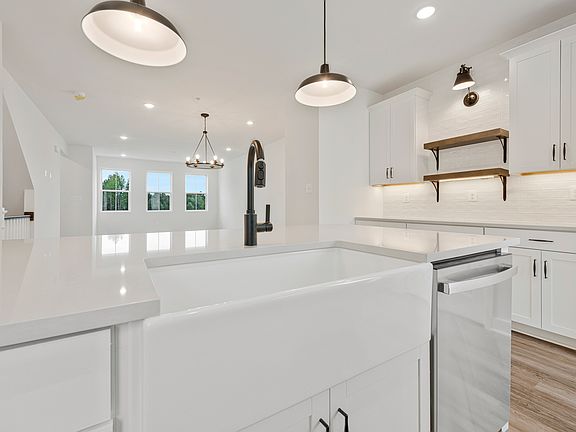 Kitchen with apron-front sink floating shelves