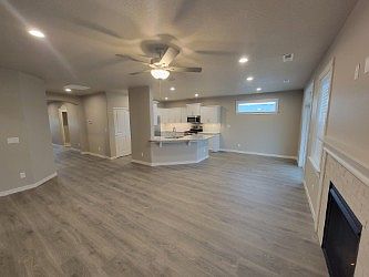 Living room looks into the kitchen /dining area. Makes the room look open and spacious. Beautiful LVP flooring.