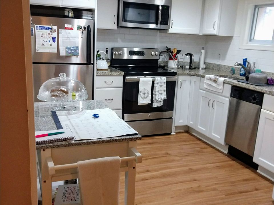 Renovated, full-sized kitchen with granite countertops.