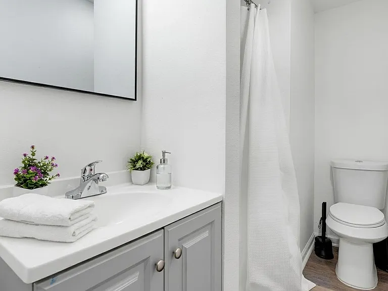 Clean full bath with a wide vanity, ample counter space, and a tub/shower combo for everyday convenience.