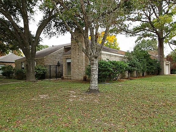 Mature trees surround this corner lot