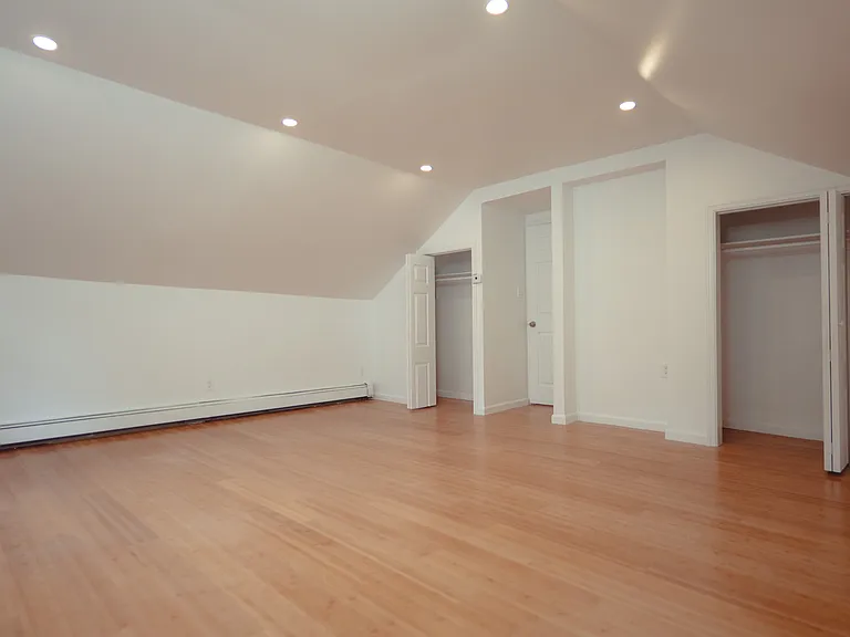 Spacious primary bedroom with two closets.