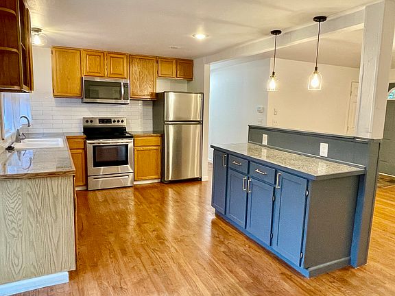 Large kitchen with newer full size appliances and granite tile countertops. Hardwoods throughout the house.