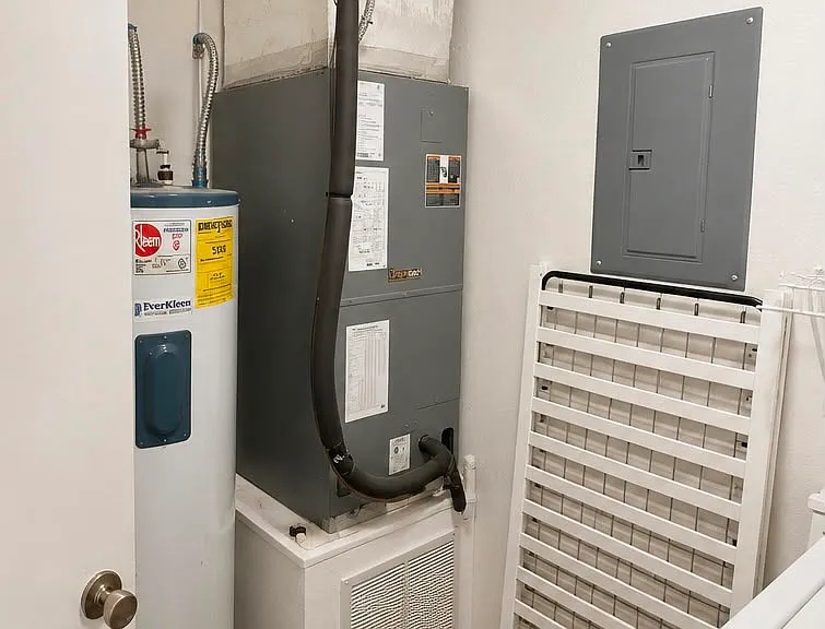 Water heather and A/C unit inside the laundry room.