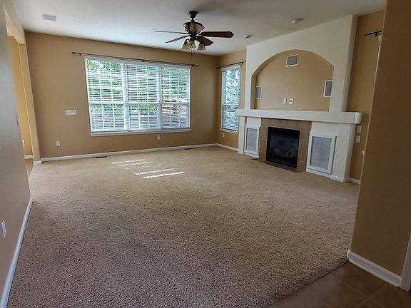 Entry into the living room with fireplace and built-in speakers