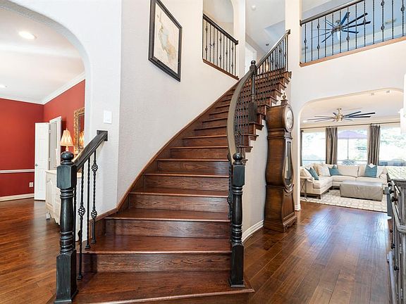 The entry provides that "WOW" moment when you open the door and view this winding staircase! Gorgeous laminate wood flooring flows throughout most of the first floor creating a seamless look, even up the staircase!