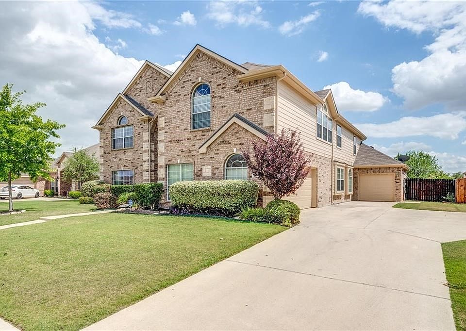 Spacious driveway with 3 car, split bay garage.