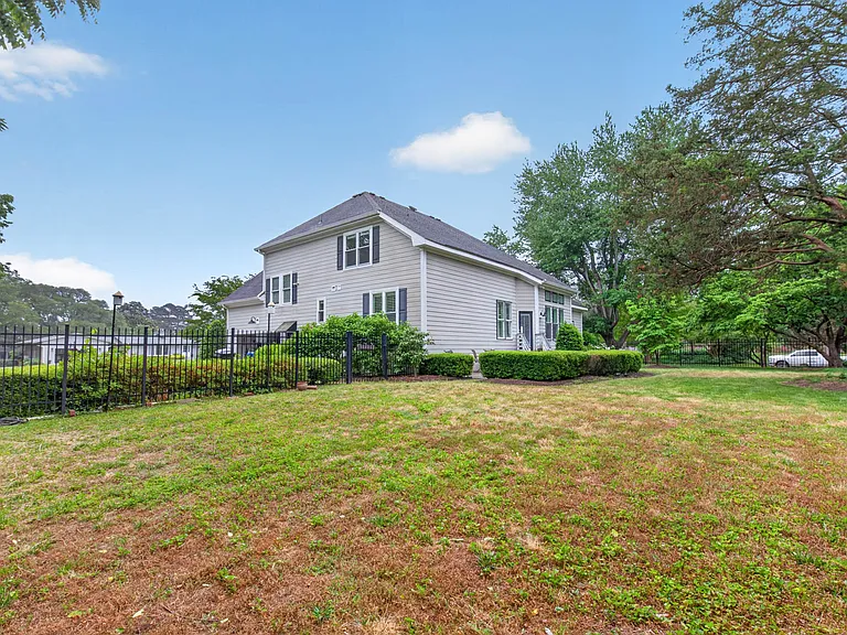 Manicured landscaping, fenced in backyard and large concrete patio