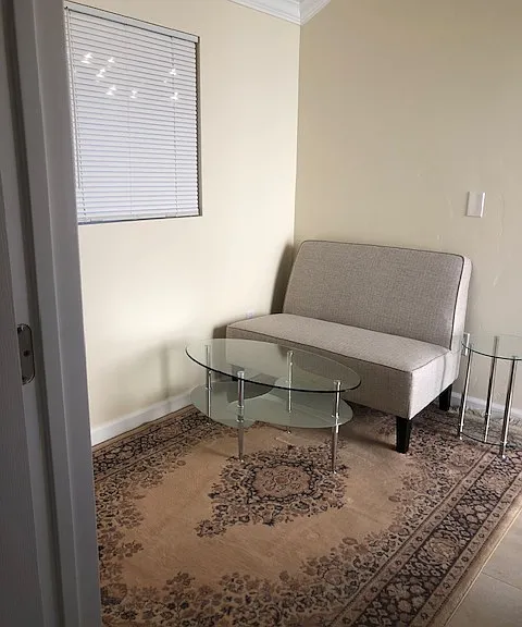 sitting room with a door between bedroom and this area