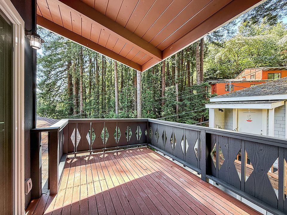 covered deck with tree views on quite street