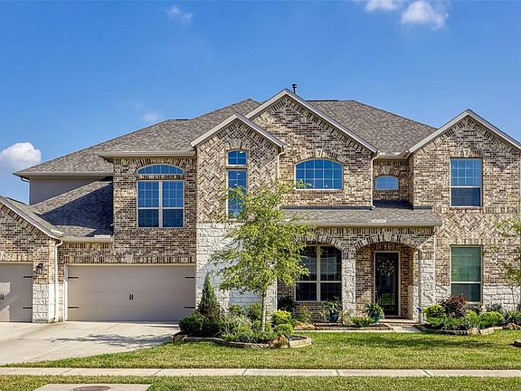 This fantastic home offers such great curb appeal with stone and brick elevation, a covered front porch and a 3-car wide garage!