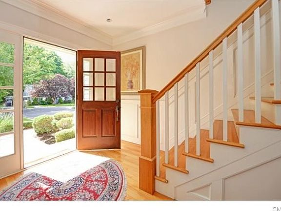 You are welcomed by a stately staircase and balcony.